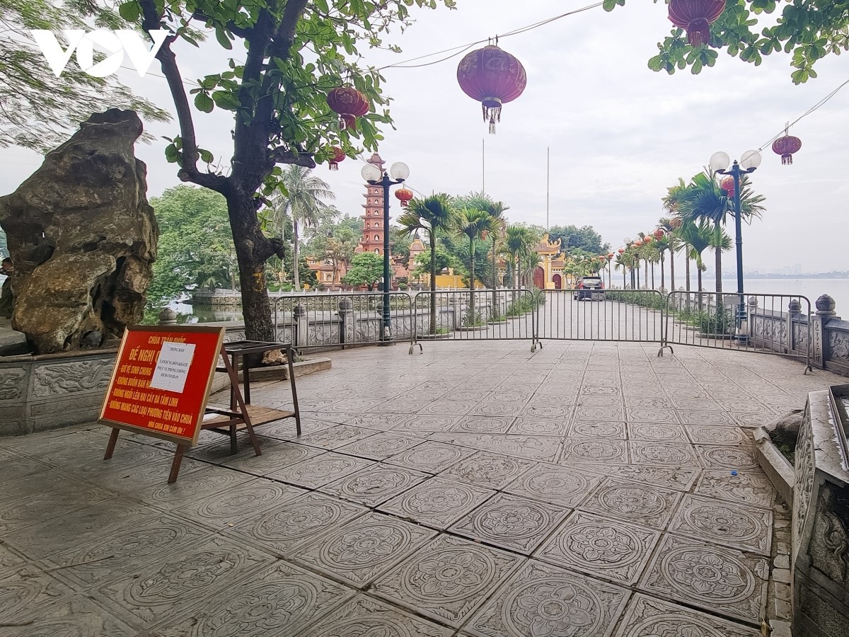 barriers are erected around the entrance to tran quoc pagoda in order to stop people from visiting the site amid covid-19 fears.